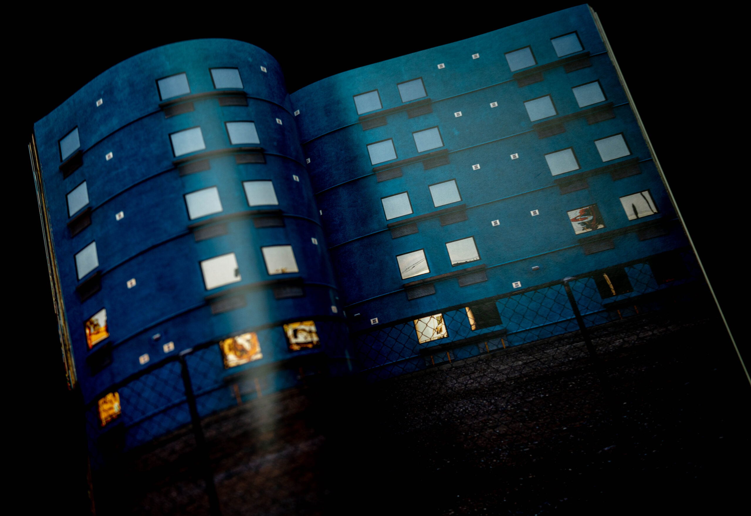 Open book showing image of apartment windows