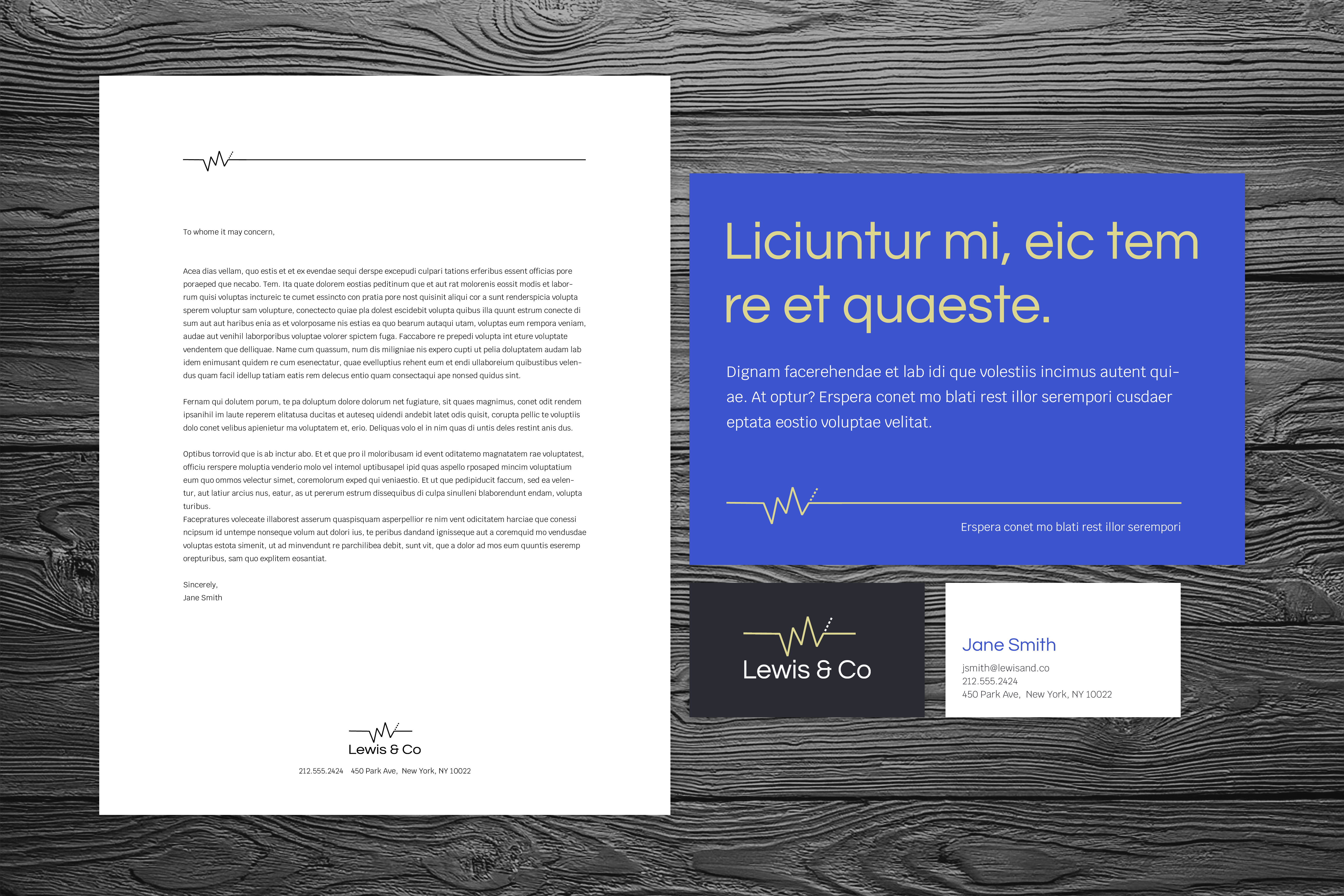 Lewis and Co letterhead, postcard, and business card on gray wooden surface